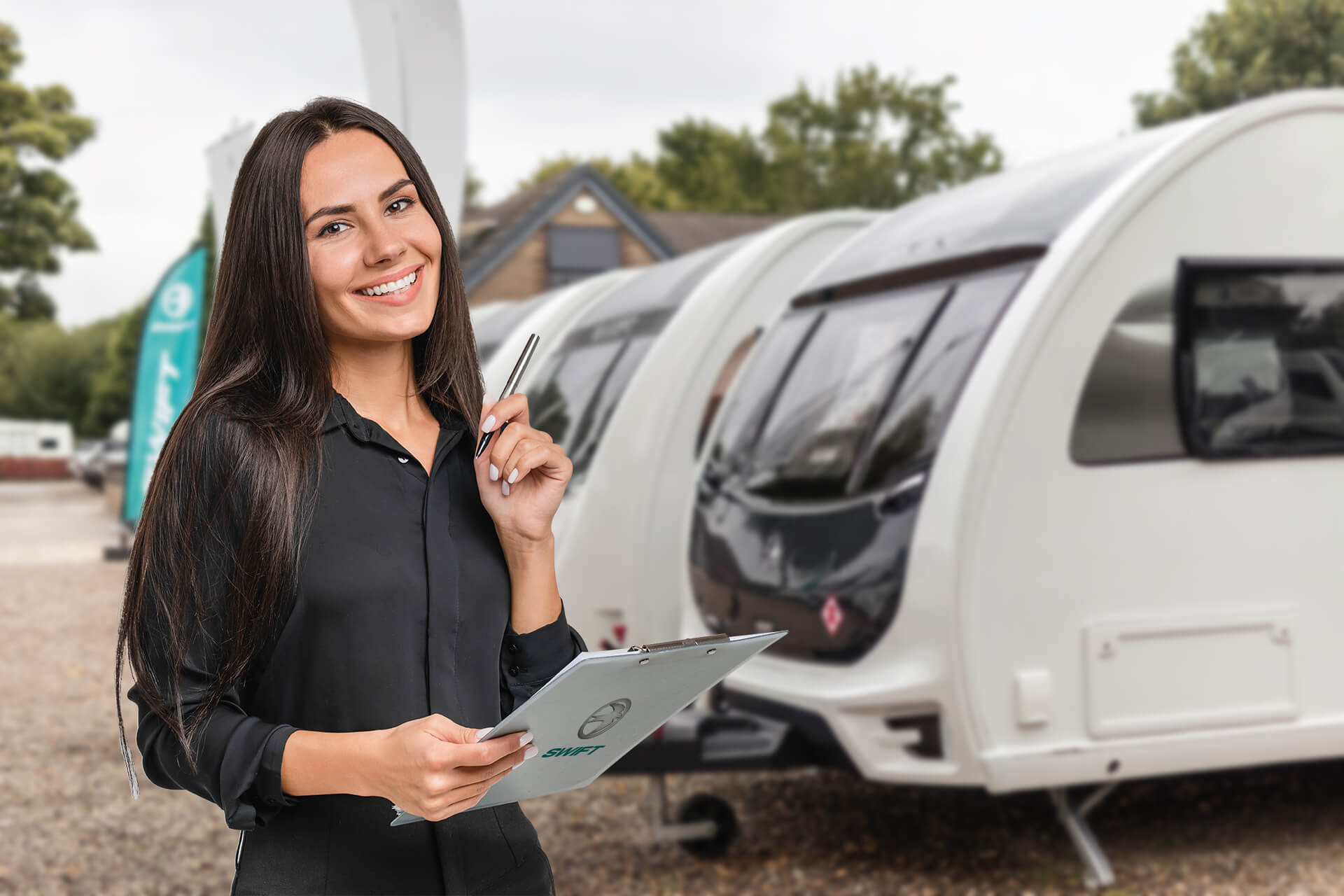 Lady with clipboard inspecting caravans